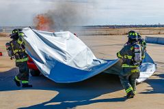Car Fire Blanket Being Placed Over Burning Card
